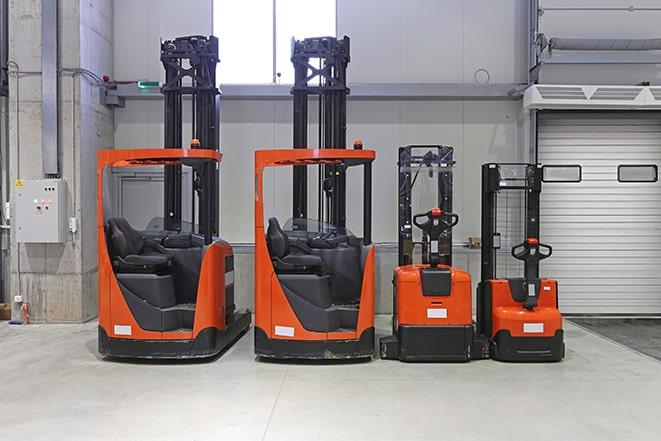 forklift trucks maneuvering in a busy warehouse